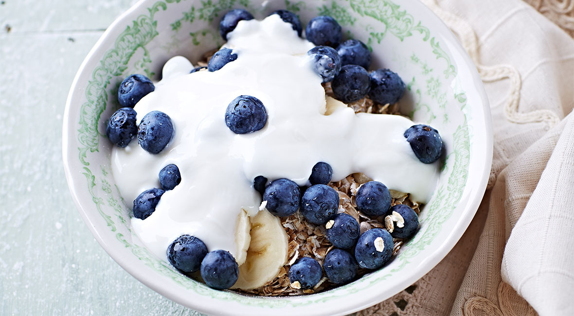 Fresh bowl of mixed fruit with cream